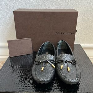 Black monogram Louis Vuitton loafers.